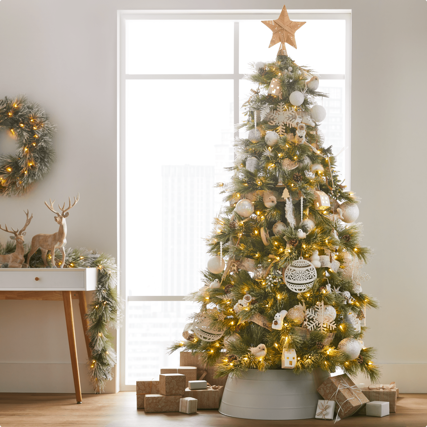 A CANVAS Charlotte Snow-Dusted Tree filled with CANVAS White decorations. 