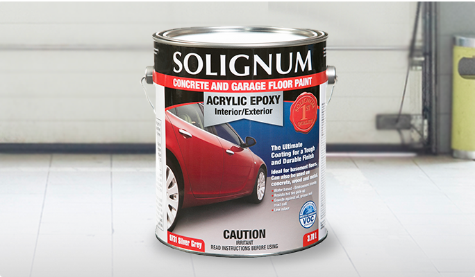 A can of Solignum Concrete & Garage Floor Epoxy Paint on the floor of a garage.