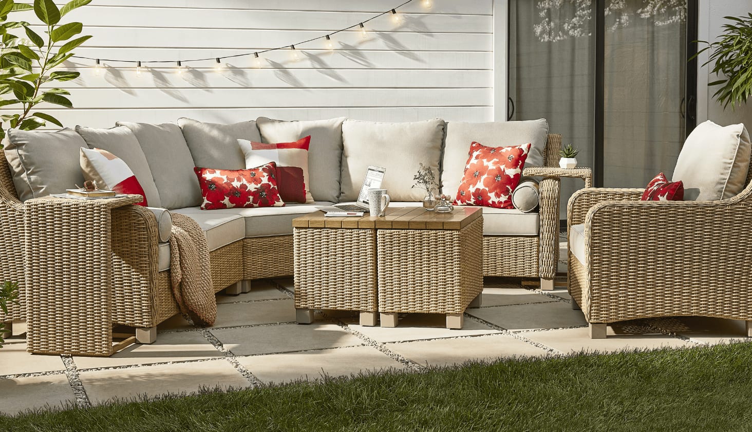 A CANVAS Moraine Sectional Set and side tables on a backyard patio.