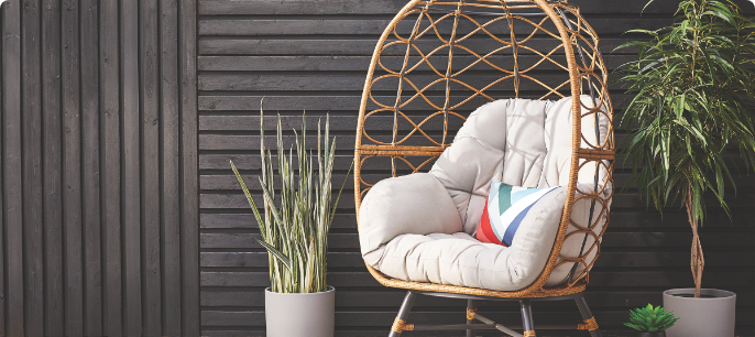 A CANVAS Sydney Egg Chair with cushions on a patio. 