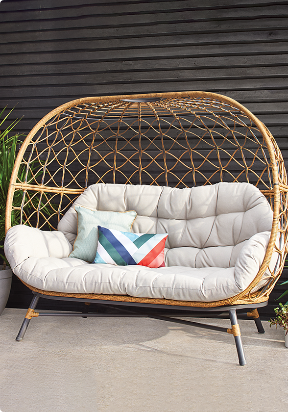 A CANVAS Sydney Double Egg Chair with cushions on a patio. 
