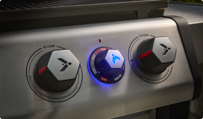 A close up of 3 BBQ dials.