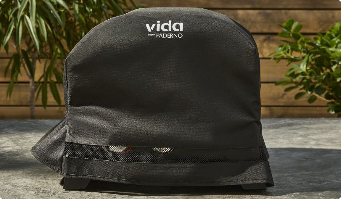 The Vida by PADERNO Gas Pizza Oven with its protective cover on.