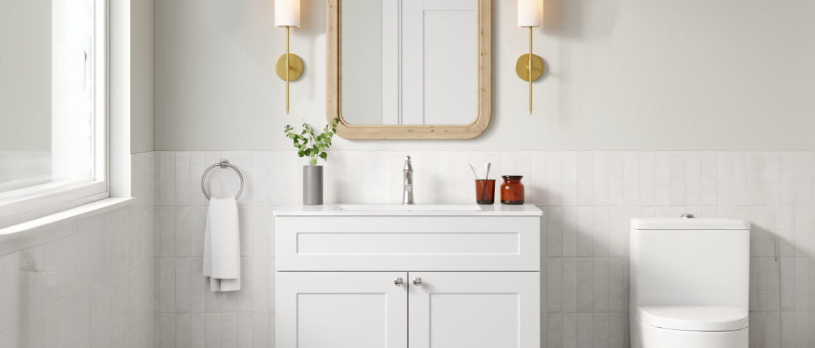 A single-faucet vanity in a stylish, all-white bathroom.