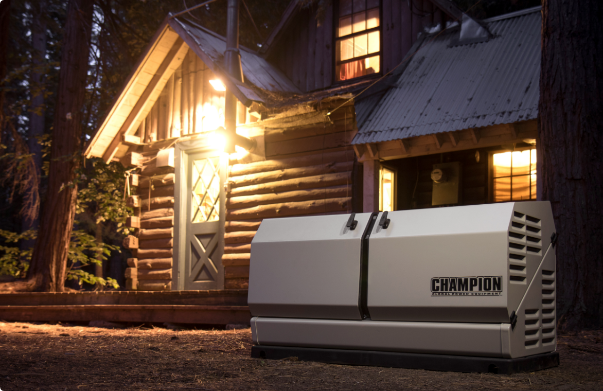 A Champion 8.5 Kilowatt Home Standby Generator outdoors in front of a cabin at night. 
