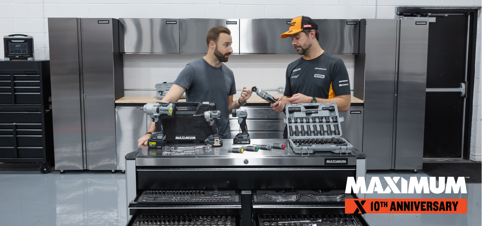 Pfaff Motorsports team members inspect MAXIMUM tools in a garage.