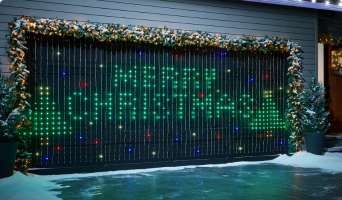 A garage decorated with curtain lights that reads ‘Merry Christmas’.