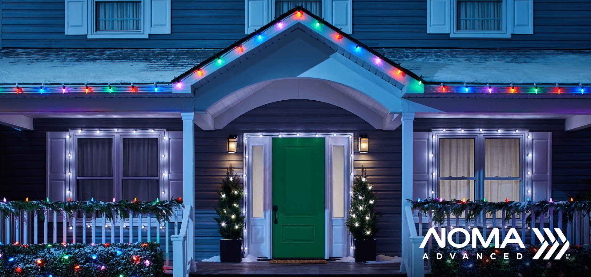 Exterior of a home decorated with Christmas decorations and colourful lights