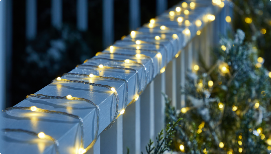 Exterior of home decorated with colourful Christmas lights