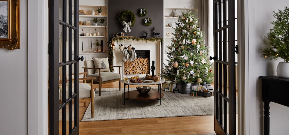 A living room decorated with CANVAS Night Before Christmas decorations. 
