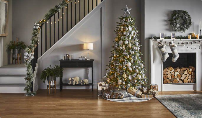 A living room with a Christmas tree and CANVAS Silver Frost decorations. 