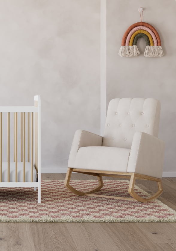 A crib, rocking chair and rainbow decoration in a nursery.