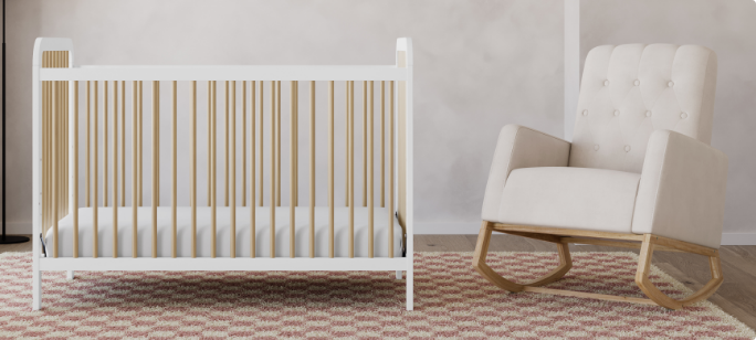 A crib, rocking chair and rainbow decoration in a nursery.