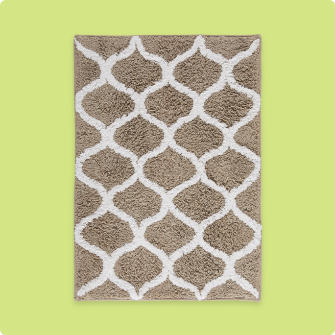A beige and white patterned bath mat.