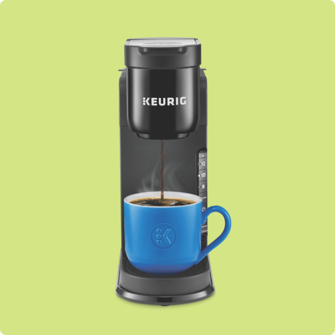 A single-serve Keurig coffee maker with a blue mug.