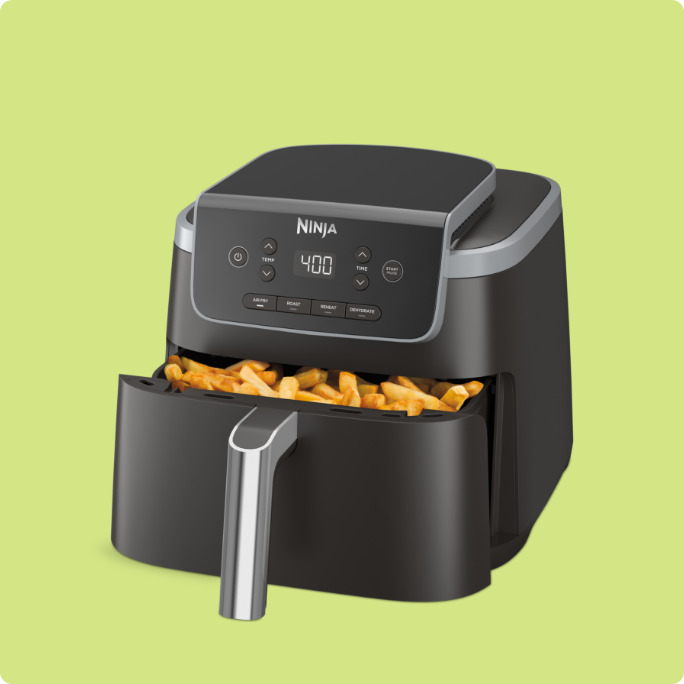 A black Ninja air fryer with fries inside.