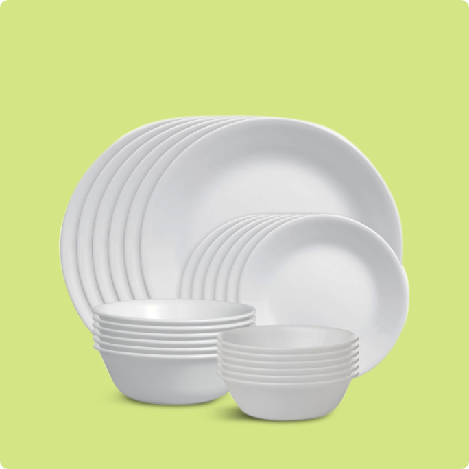 A white Corelle dinnerware set including plates and bowls.