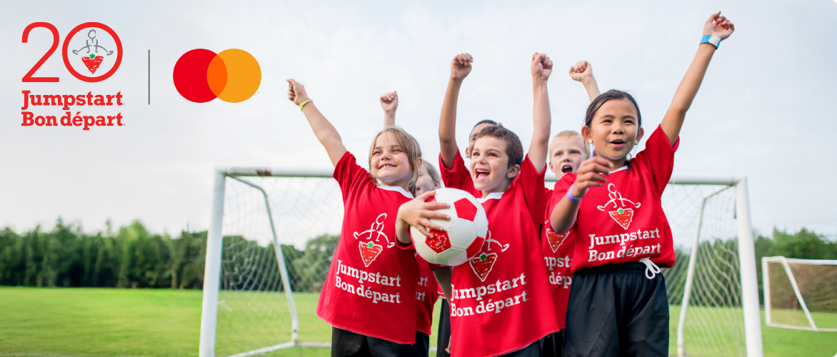 Children in red jerseys celebrating on a soccer field, with the 20th Anniversary Jumpstart and Mastercard logos displayed.