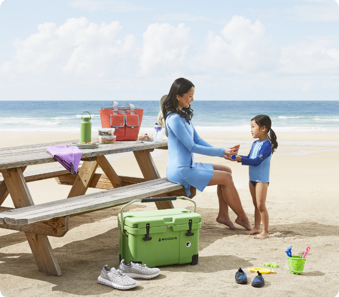 A family enjoying a picnic at the beach.