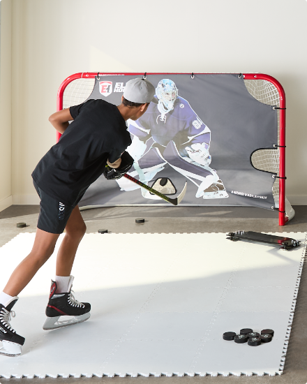 A person playing hockey indoors.
