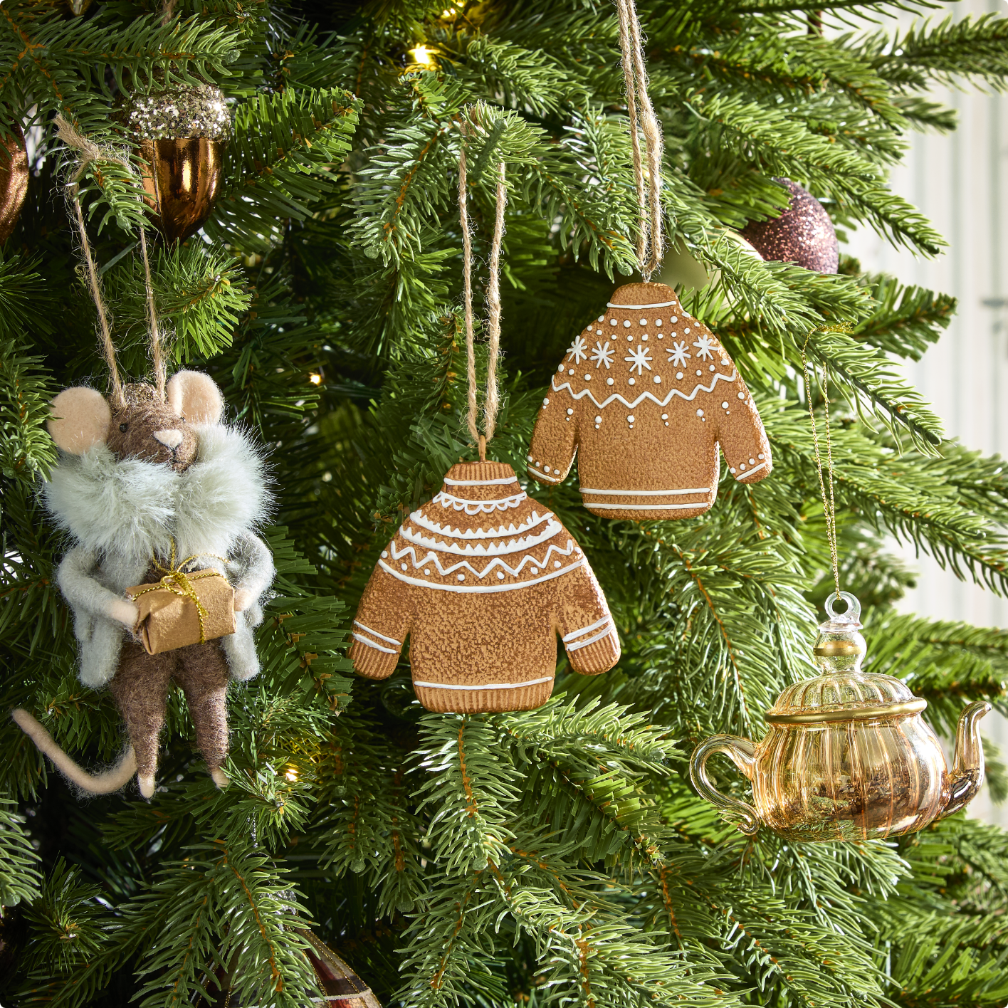Various twinkle light decorations displayed on a snowy front porch.