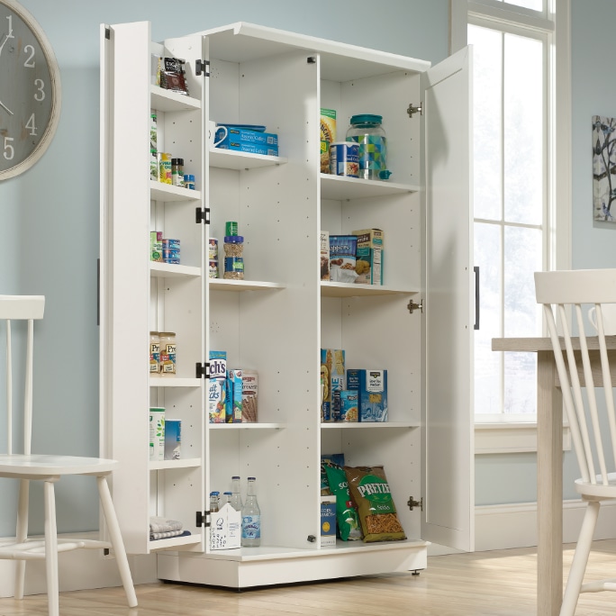 A tall white pantry cabinet with open doors displaying food items.