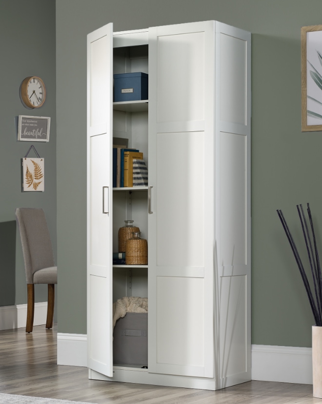 A tall white storage cabinet with open doors showing items inside.