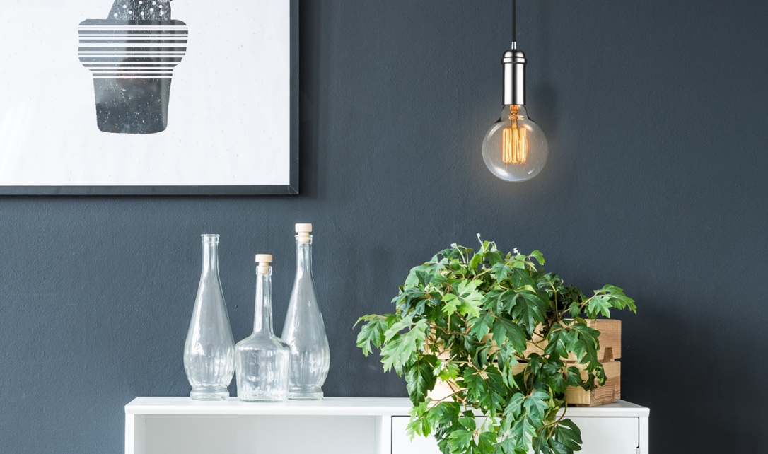 Un luminaire suspendu moderne doté d'une ampoule à incandescence au-dessus d'un comptoir de cuisine.