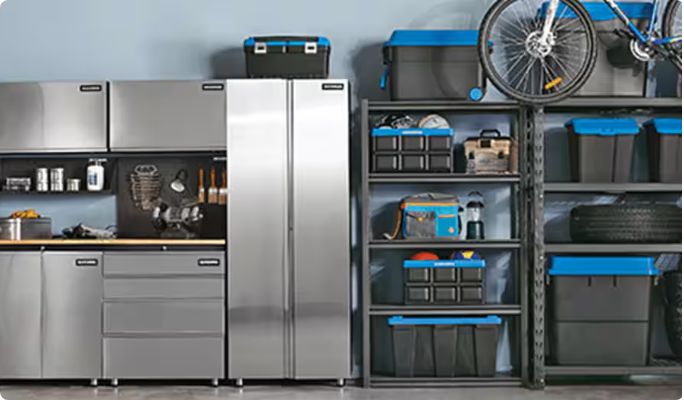 Organized garage with storage cabinets, shelves, bins and various tools neatly arranged.