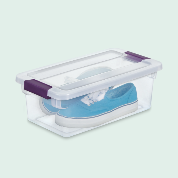 Clear shoebox storage bin containing a pair of blue sneakers.