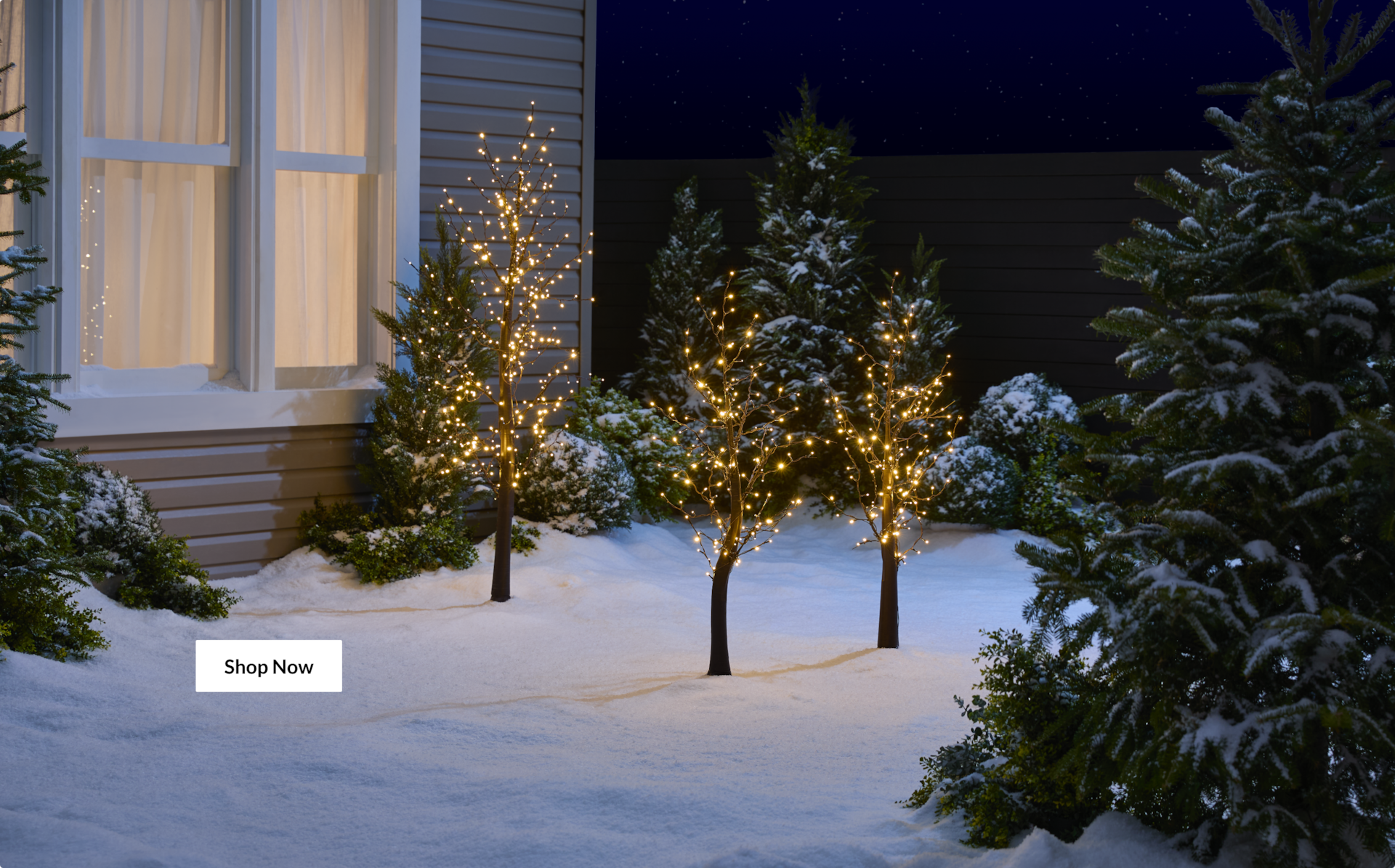 A house decorated with colourful lights from the NOMA Smart Collection.