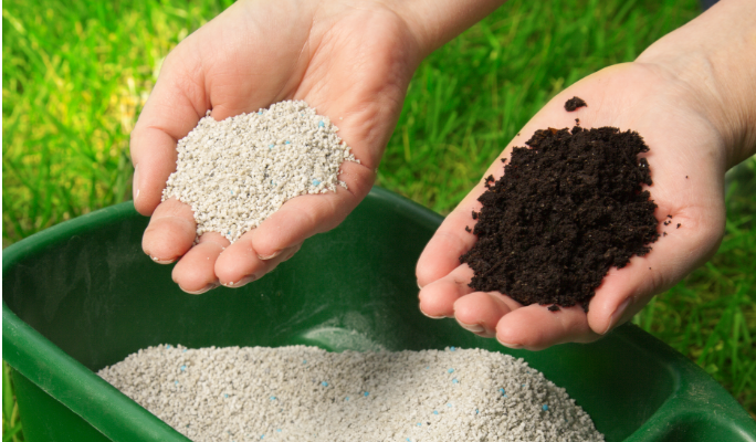 Hands holding granular and organic fertilizers over a container.