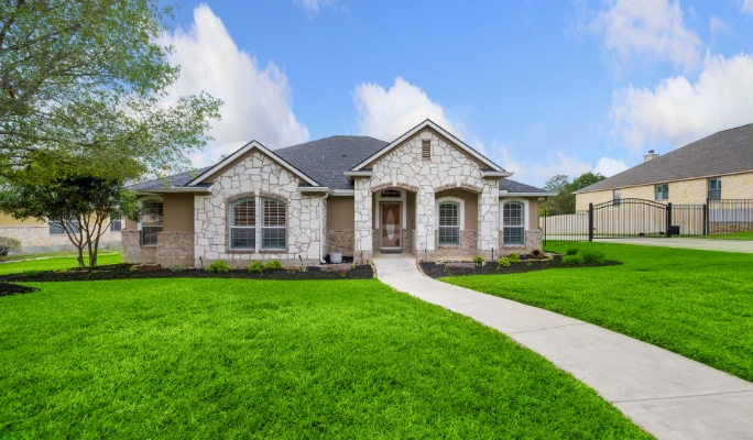 Beautifully manicured lawn in front of a suburban house.