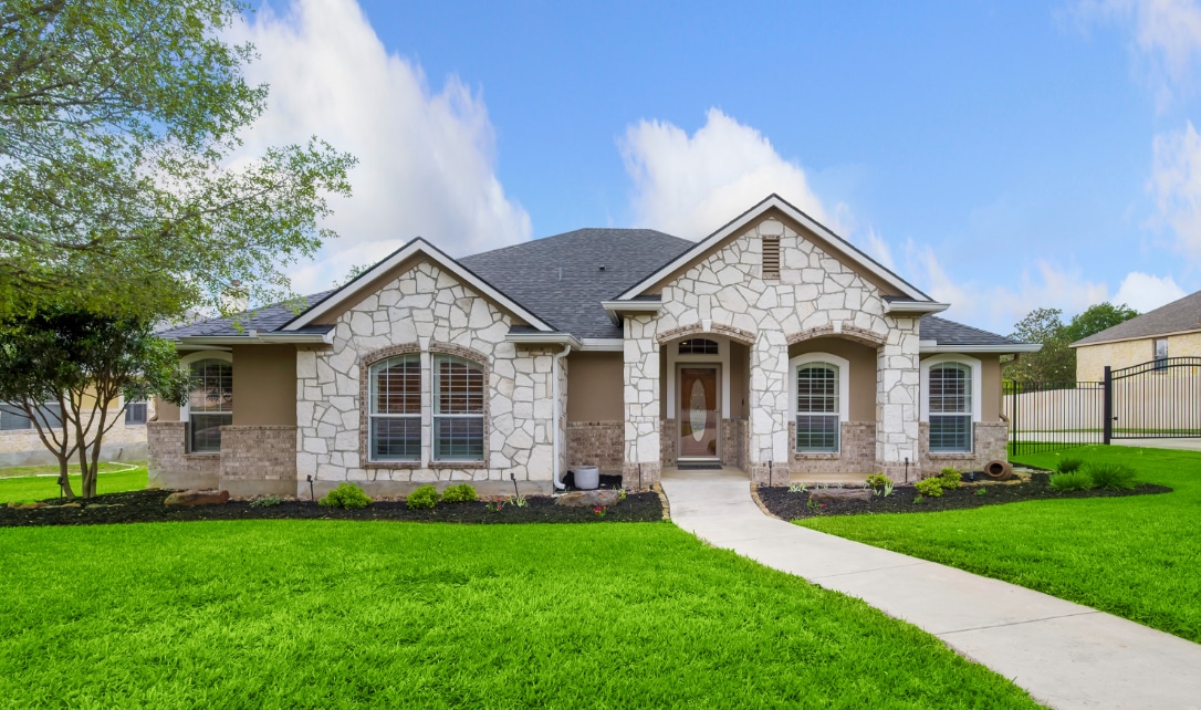 Front view of a single-story house with a well-maintained lawn.