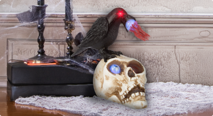 An animated Halloween decoration featuring a crow with glowing eyes perched on a skull.