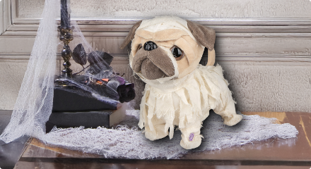 A pug Halloween decoration dressed as a mummy.