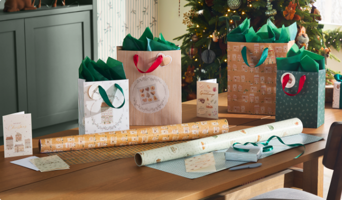 CANVAS Holiday Homecoming Collection gift wrap and bags on a table. 