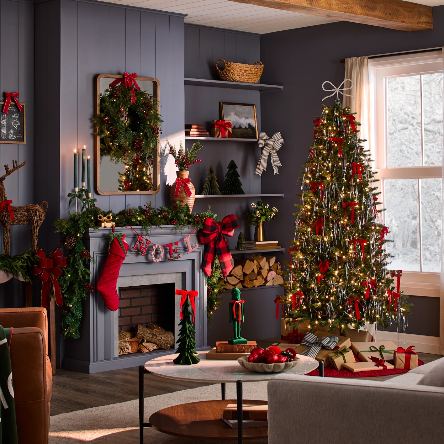 Decorated Christmas tree in a festive living room covered in red bows with a fireplace, stockings, wreaths, and additional holiday decor.