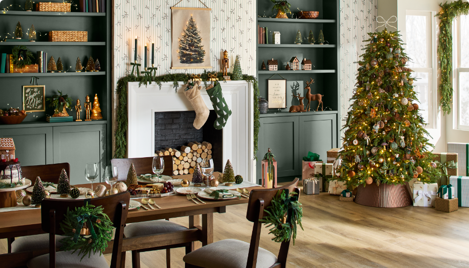 A festive dining room with a decorated Christmas tree, fireplace with stockings, and a table set for a holiday meal.