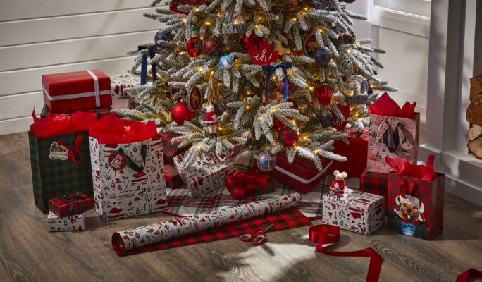 Red and white wrapped presents under a decorated Christmas tree.
