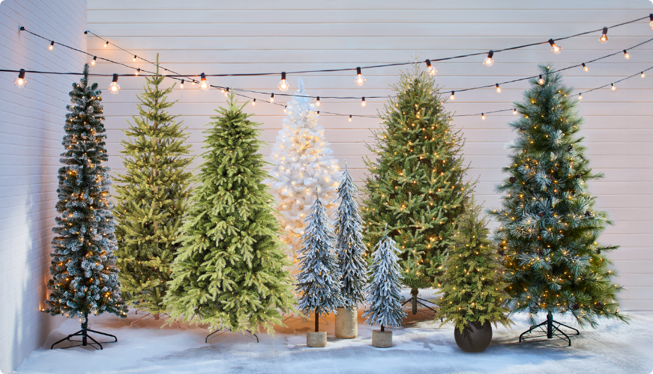 A brass CANVAS Noel taper candle holder on a table in a living room.