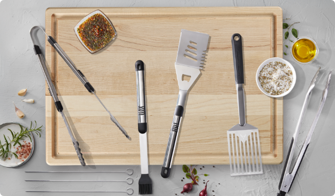 Various BBQ accessories on a cutting board.