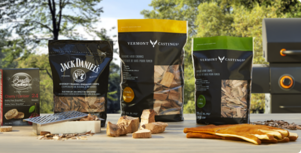 A variety of wood chips, pellets & bisquettes on a table.