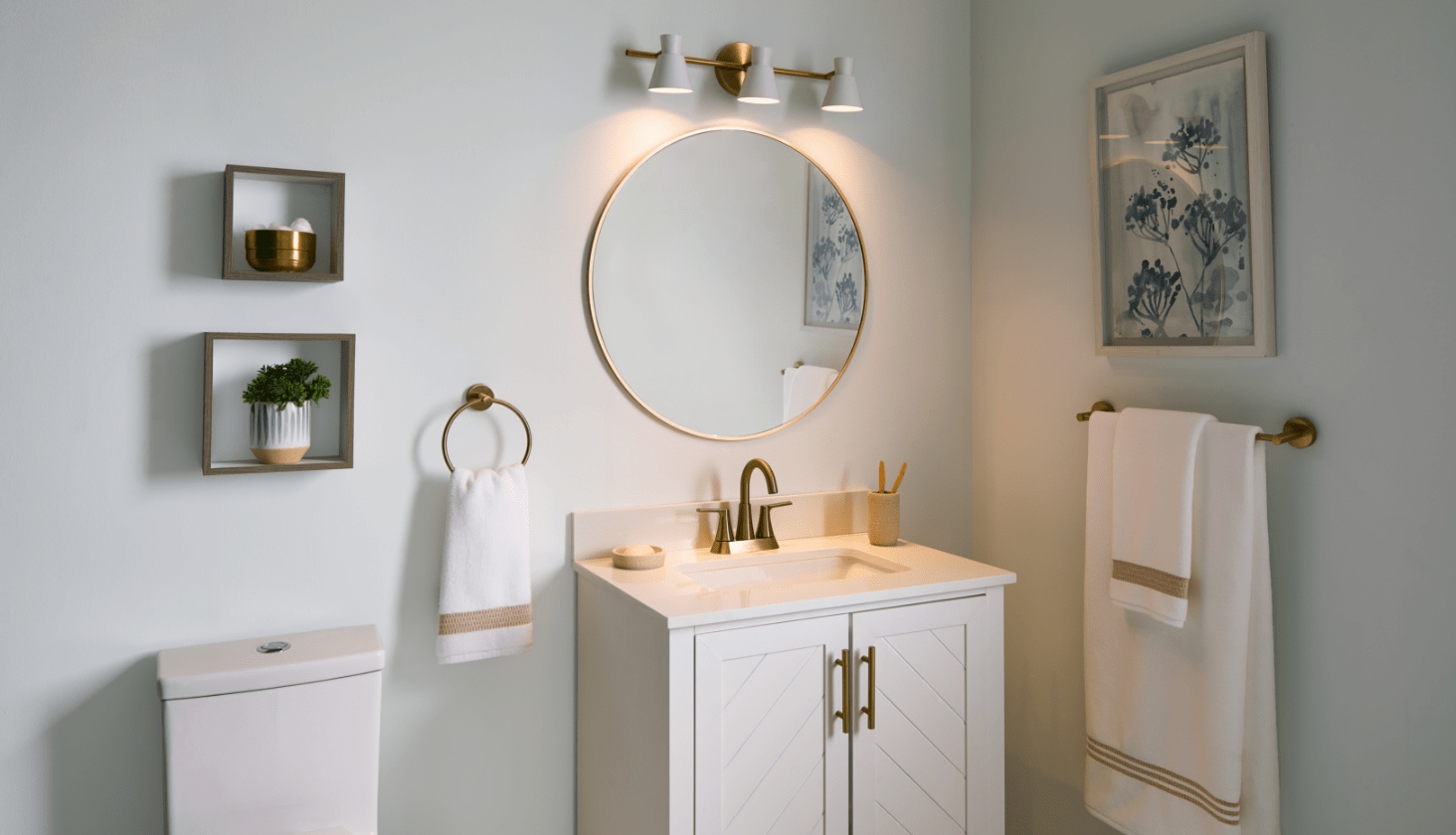 A white bathroom featuring two CANVAS Langford 2-Door Bathroom Vanities with gold fixtures.