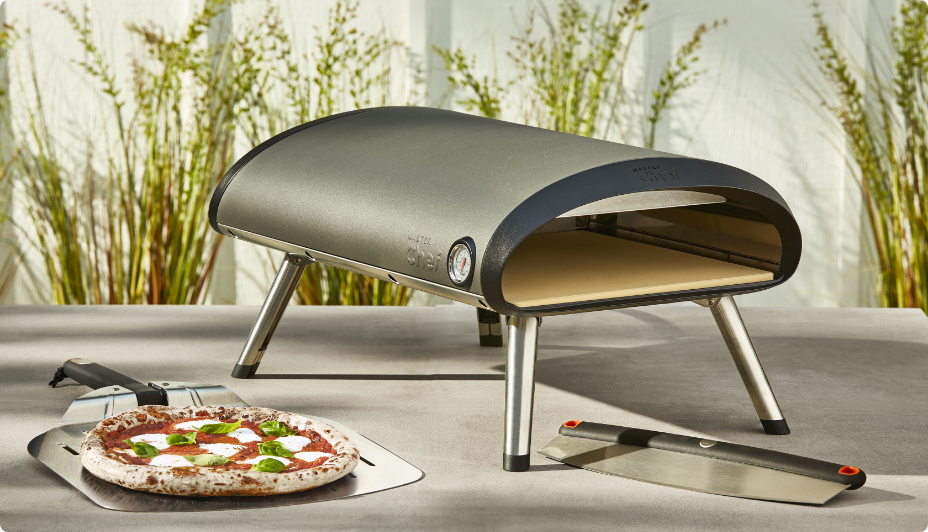 Vida by PADERNO Pizza Oven and pizza on concrete table. 