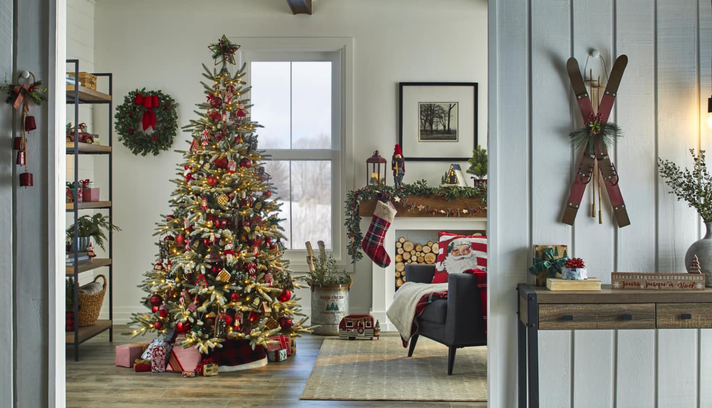 A living room decorated with a Christmas tree and a variety of decorations.