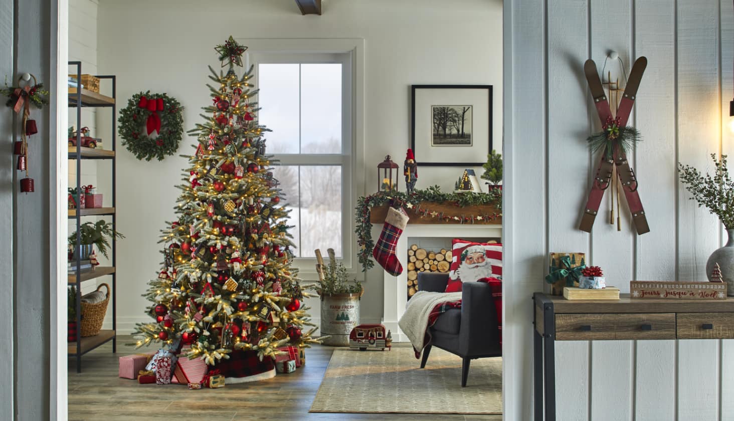 A living room decorated with a Christmas tree and a variety of decorations.