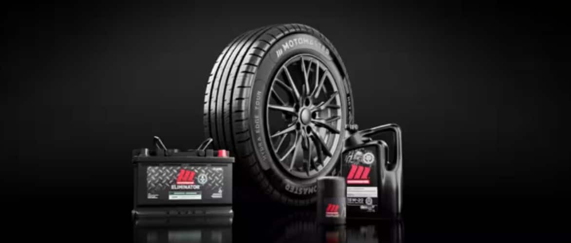 A group of MotoMaster products including power pack, tire, oil filter and motor oil.