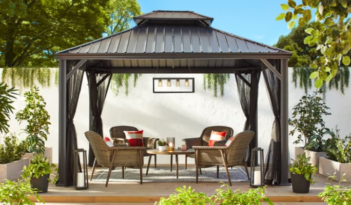 CANVAS Hunter club chairs and table under a Horizon pergola in a backyard