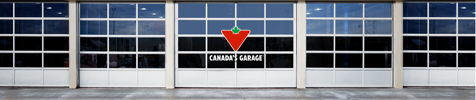 The “Canada’s Garage” logo in front of a row of service-bay doors.